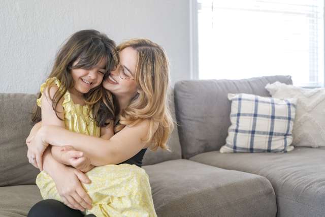 Mom Klarissa Hope hugs her smiling daughter, Raylee Osuna.