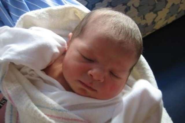 Zoey Jeanne, newborn swaddled and sleeping