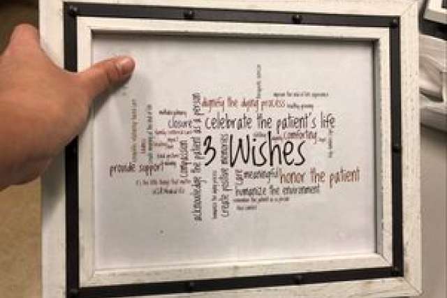 Hand holding a framed word cloud titled "3 Wishes" with various supportive themes.