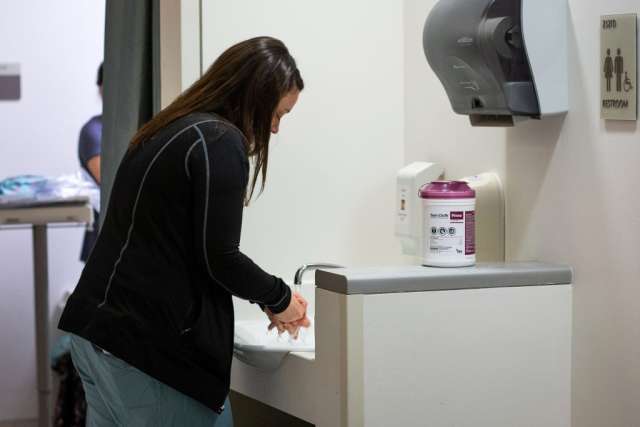 Karleen Wray washing her hands in the sink