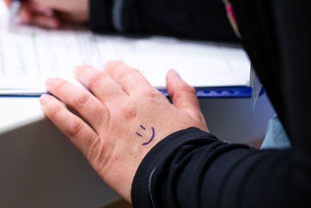 The back of Karleen Wray's hand which has a smiley face drawn on it