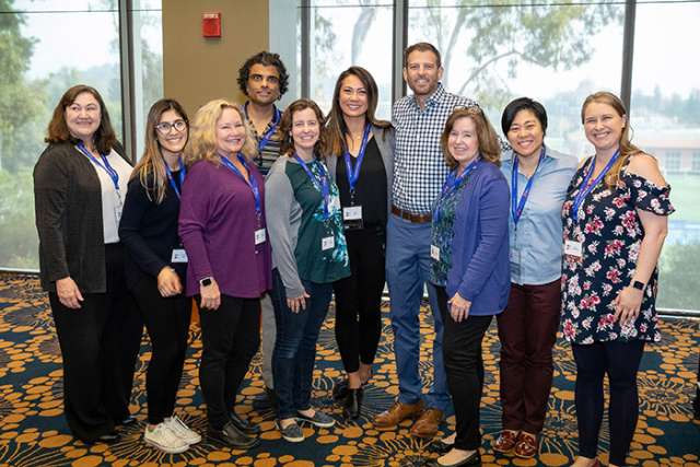 Haley and Tyler Bacon surrounded by eight of the 26 people whose blood and platelet donations preserved his life during cancer treatment at UCLA.