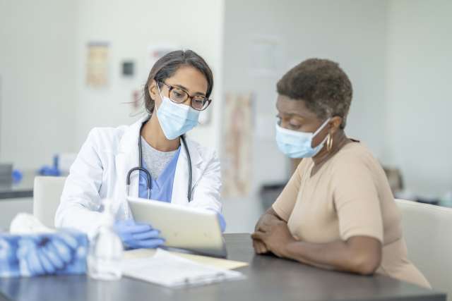 Female doctor and female patient discuss treatments