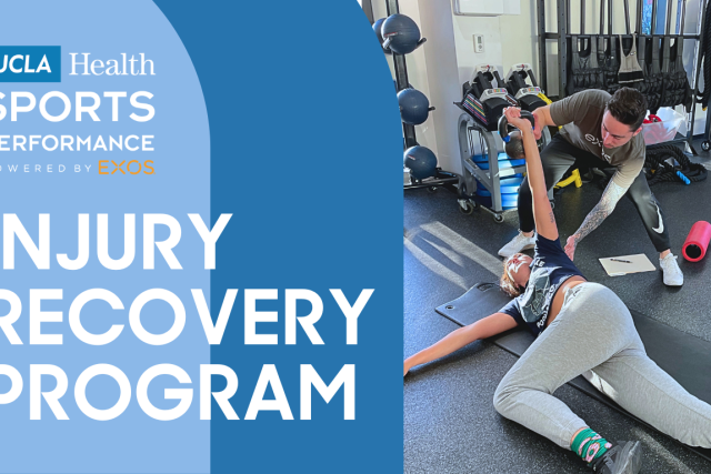 A trainer assists a person stretching on a mat in a gym, with "UCLA Health Sports Performance Injury Recovery Program" text.