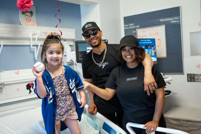 Los Angeles Dodgers all-star Mookie Betts and his wife, Brianna Betts, visit with Stella, a patient at Mattel Children's Hospital. 