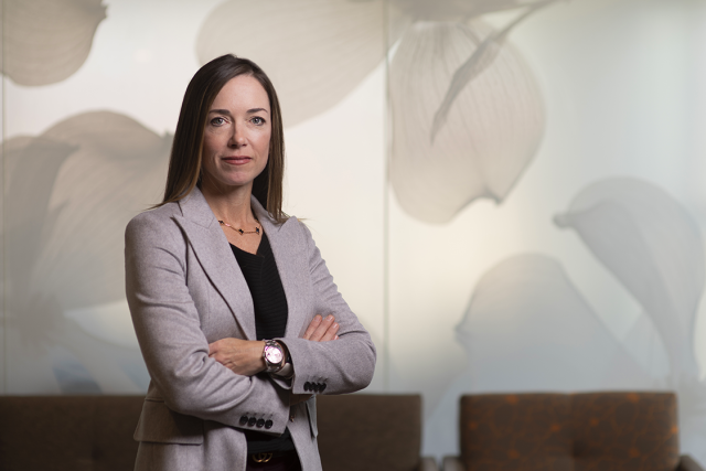 UCLA breast cancer researcher Dr. Sara Hurvitz posing with crossed arms and wearing a black shirt and a gray suit jacket.
