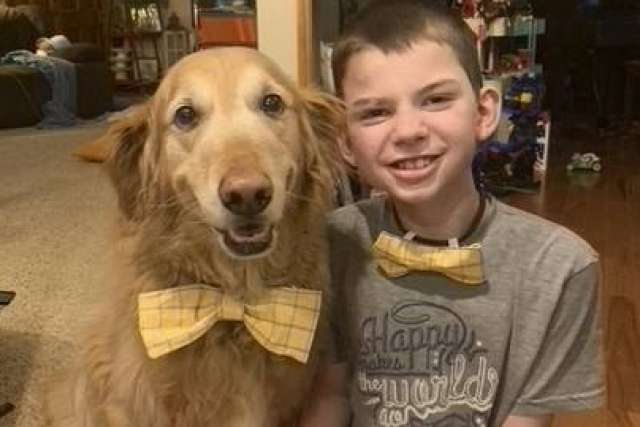 Brock Graham and his yellow golden retriever wearing matching bowties