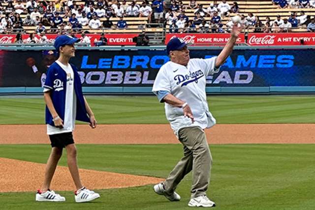 Dr. John Glaspy, accompanied by his grandson Braden, threw out the ceremonial first pitch at a recent Dodgers game. (Photo by Catherine Boyer)