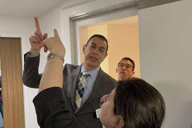 COO Richard Azar, Suzanne Kiely, and Dr. Erick Cheung discuss ceiling fixtures in a prototype patient room. 