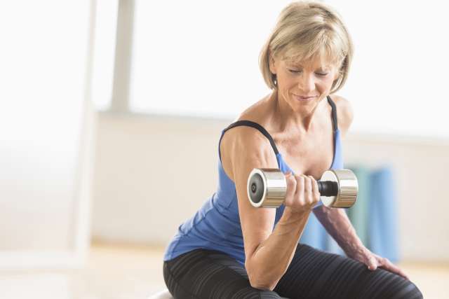 Older woman lifting a dumbbell for exercise 
