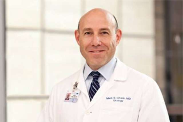 Mark Litwin in white coat and tie, smiling headshot