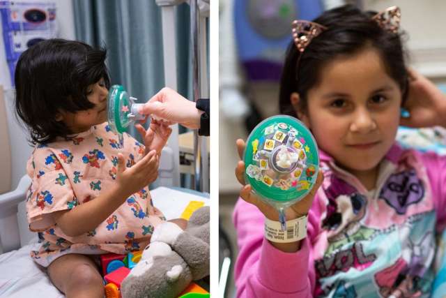 Six year old patient, Kayla holding up her breathing mask that is covered in stickers