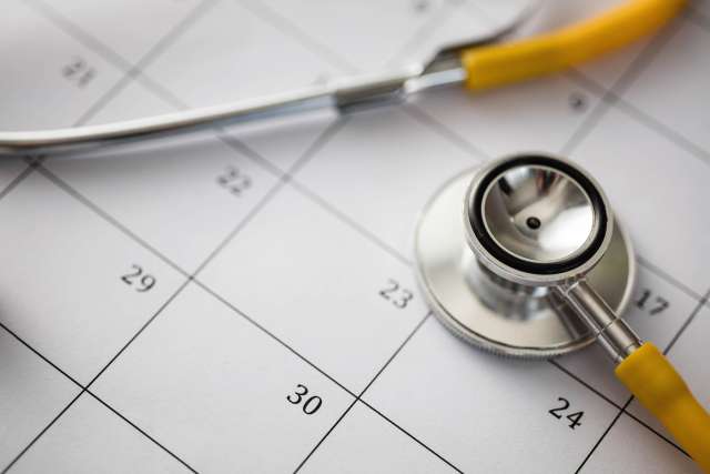 Closeup of a stethoscope resting on a calendar