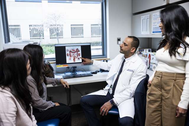 Doctor, medical staff examine scan