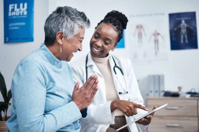 Female doctor fills out a form with a patient