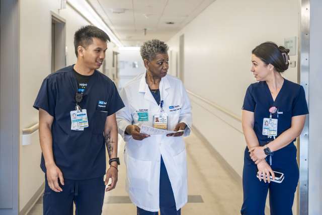 Unit director Grace Mayne remains accessible to her team, answering nurses’ questions as she moves between duties