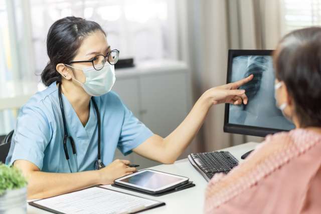 Doctor shows a scan to a lung cancer patient