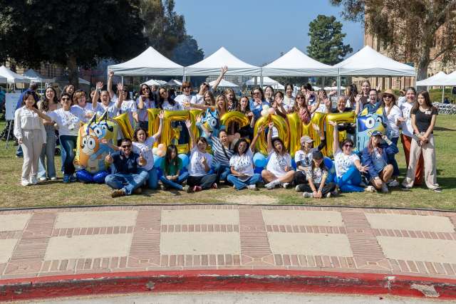 UCLA Health staff post for a group photo with balloons spelling welcome.