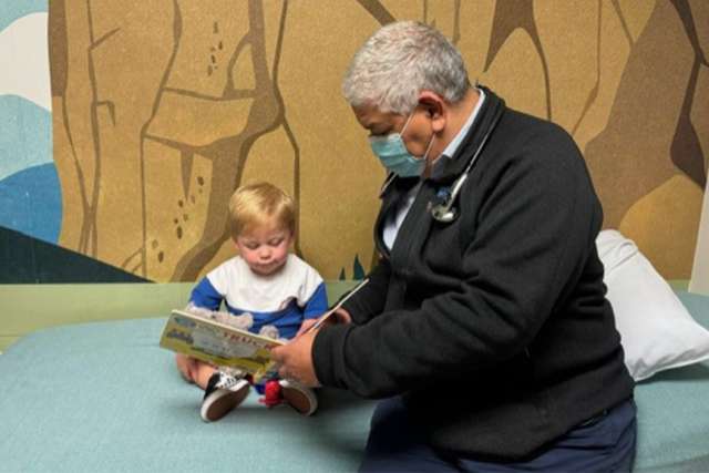 Dr. Juan Alejos reads to Levi Jonathan.