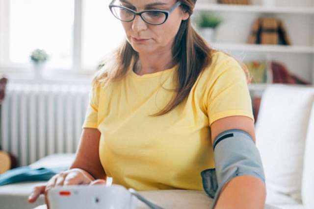 Woman measuring her blood pressure