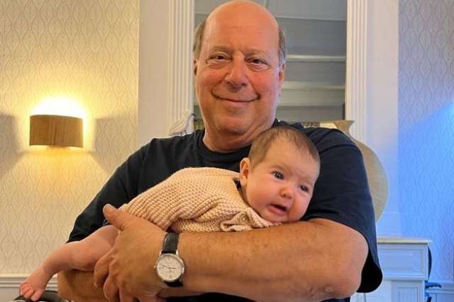 Dan Freeman holds his grandchild