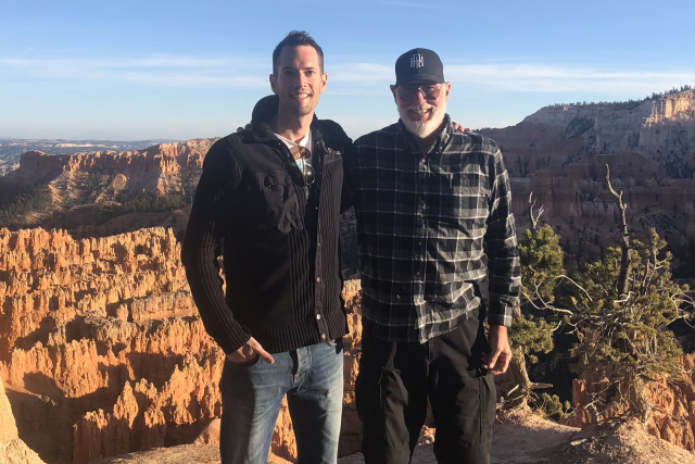Dr. Justin McWilliams with his father, Dr. Thomas McWilliams pose for a photo outdoors.. 
