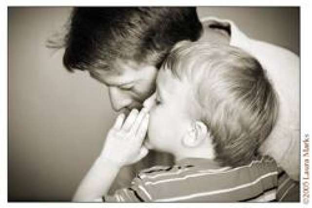 Robert's son whispering into his ear