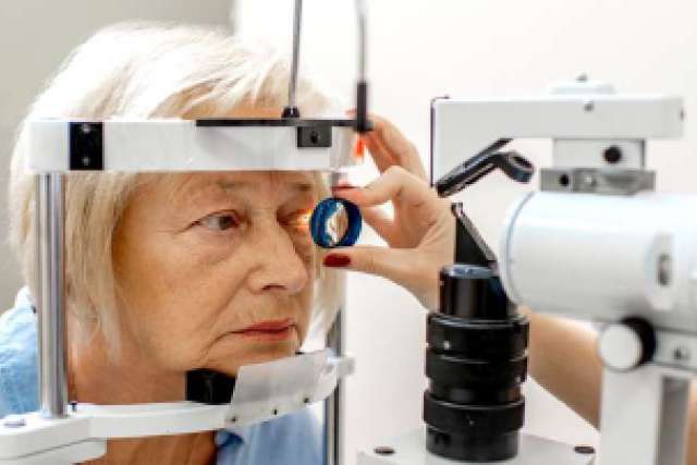 female patient exam with gonioscopy lens