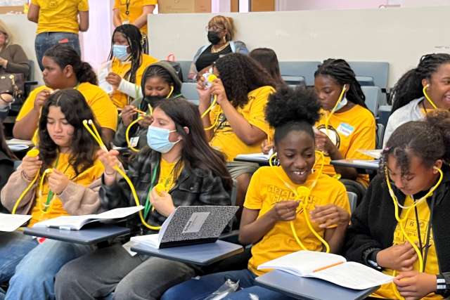 Middle-school students participating in an Early Cardiovascular Health Outreach event at Charles Drew University receive plastic stethoscopes. (Photo by Sandy Cohen)