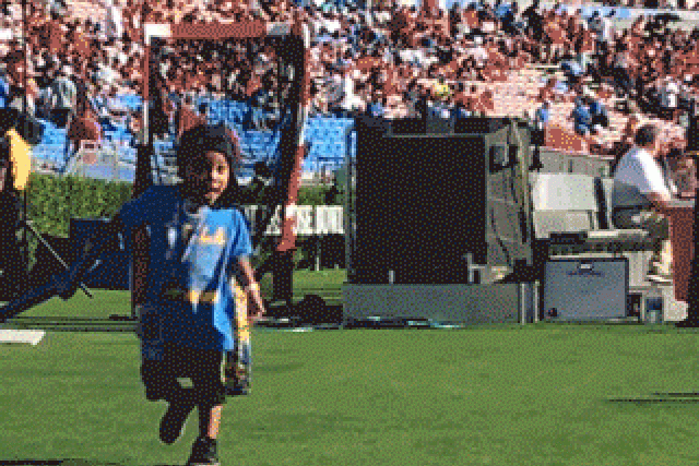 a boy named Jackson Running in an open field wearing a UCLA shirt