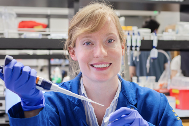 Danielle Morrow, PhD, in a UCLA lab, pipetting samples during glioblastoma lipid metabolism research.