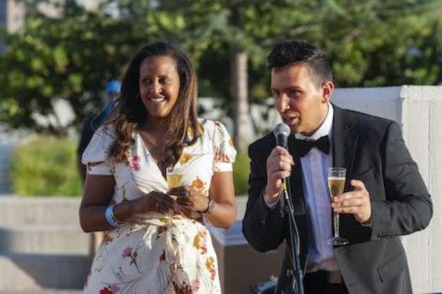 Woman and man speak at graduation celebration