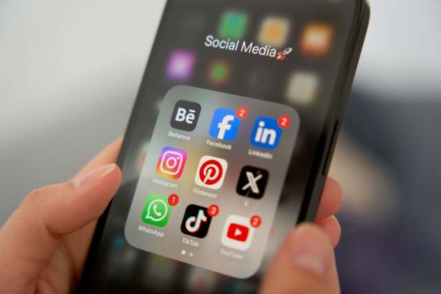 Smartphone 'Social Media' folder showing app icons like Instagram, Facebook, TikTok