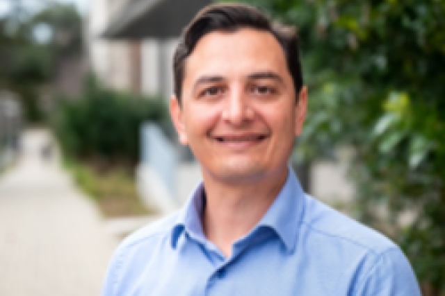headshot of Dr. Chris Moriates in blue shirt