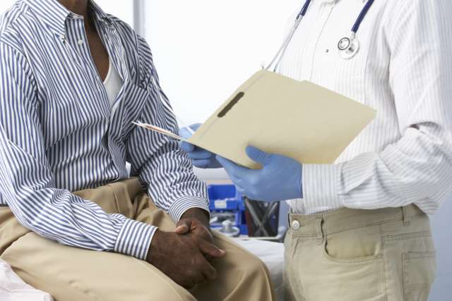 Doctor consulting with cancer patient