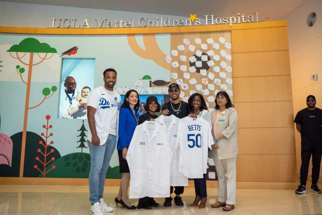 Los Angeles Dodgers all-star Mookie Betts and his wife, Brianna Betts, stand with UCLA Health's Mikel Whittier, left, Johnese Spisso, Dr. Medell Briggs-Malonson and Dr. Sherin Devaskar.