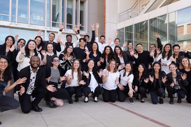 A group of medical professionals from UCLA Primary Care Program smiling outside of a building