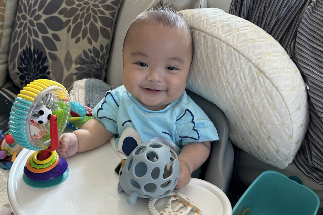 Francis Saputra in his high chair at home.