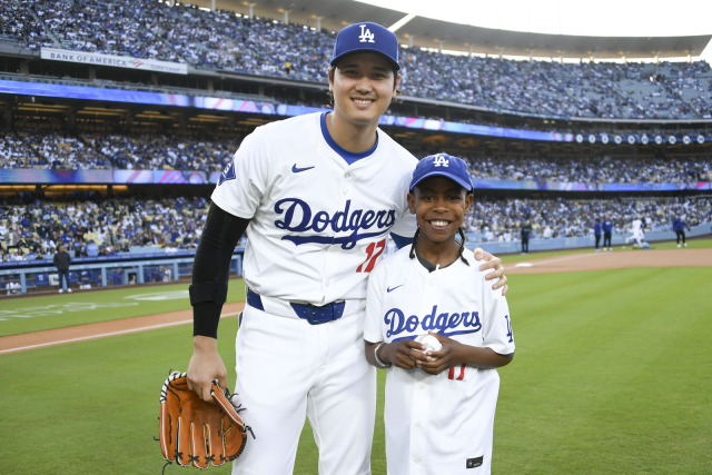 UCLA Health pediatric cardiology patient, Albert Lee posing with Shohei Ohtani in Dodger Stadium field.