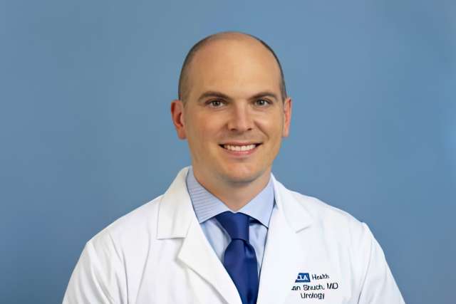 Headshot of Dr. Brian Shuch in white coat and blue tie