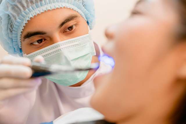 Dentist examining patient's mouth