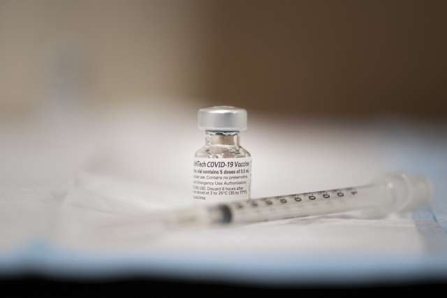 COVID vaccine vial and needle