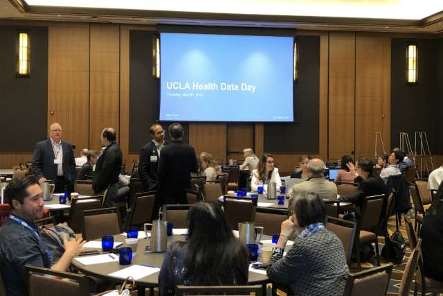 Participants engaging in discussions at UCLA Health Data Day event.