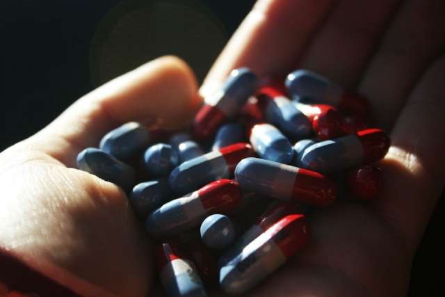 Hands holding prescription drugs