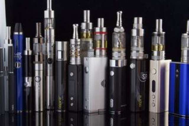 A variety of e-cigarettes and vaporizers lined up for display.