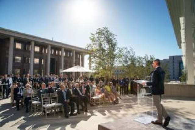 A speaker addresses a crowd at the UCLA Lew Wasserman Building opening event.