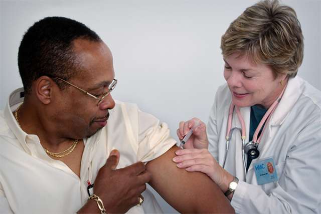 Doctor administering shot to patient