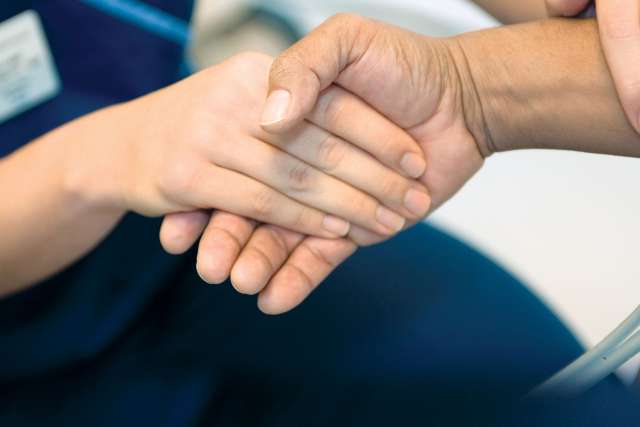 Hand of a patient and physician