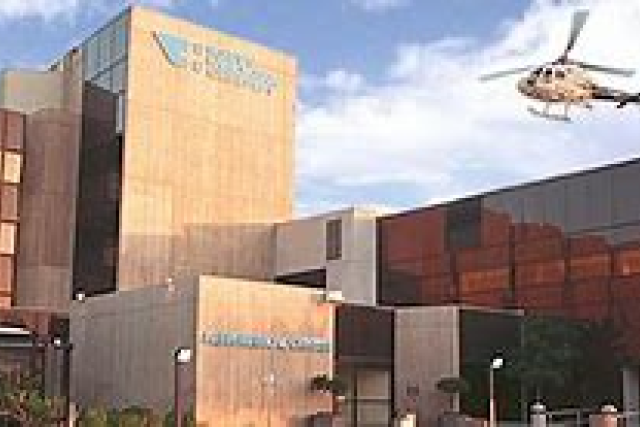 Kern Medical center building entrance with a helicopter above.