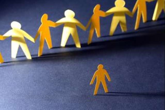 Colorful paper cutouts of people holding hands, with one figure separated from the group.